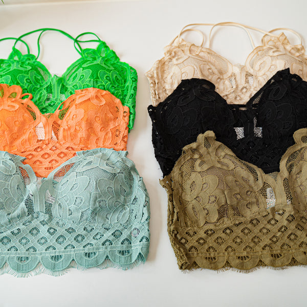 Lace detail bralettes stacked in rows in green, orange, sage, beige, black and taupe